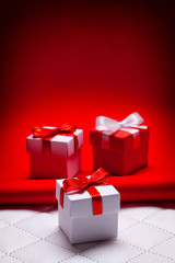 Three white and red gift boxes on red and white background