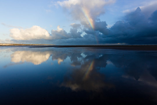 Reflection Of A Partial Rainbow And Parting Storm Clouds, Red Wharf Bay, Anglesey