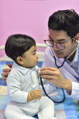 The doctor is playing with a child who is a patient or a vaccine at the hospital.