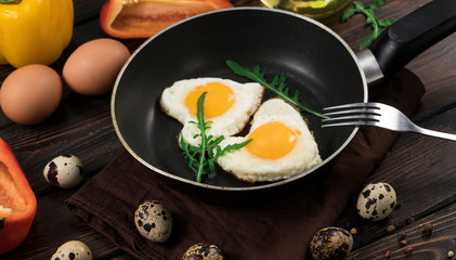 Fried eggs in the form of a heart in a skillet