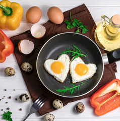 Fried eggs in the form of a heart in a skillet