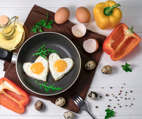Fried eggs in the form of a heart in a skillet