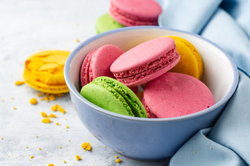 Colorful french macarons on concrete background. Selective focus.