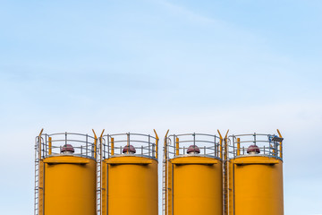 Four silos in front of blue sky © Andy Hoech