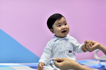 The doctor is playing and getting acquainted with the little boy.Young doctors and children who are treated. Children get vaccinated at the hospital