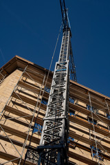 scaffolded house with a crane