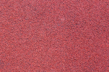 Fototapeta premium Running track sports texture. Running track rubber cover. Tartan track material is the trademarked all-weather synthetic track surfacing for athletics made of polyurethane. Red tartan athletic running