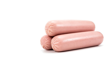 Three raw sausages in polyethylene shell isolated on white background.