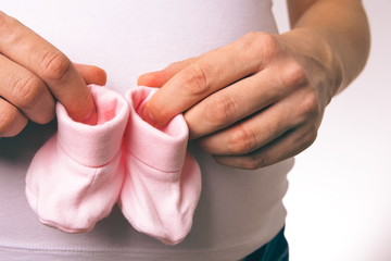Pregnant Woman Holding Baby Socks