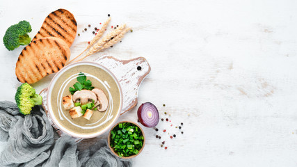 Cream soup of mushrooms in a bowl with toasted bread. Dietary food. Top view.