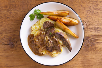 Beef liver with pears and mashed potato. View from above, top studio shot