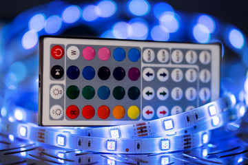 RGB LED light strip with remote control in front of colorful bokeh metal diamond plate background