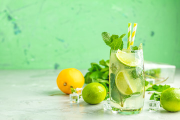 Mojito cocktail with lime and mint in highball glass