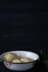 Ready meal - dumplings on a black cement background