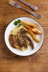 Beef liver with pears and mashed potato. View from above, top studio shot