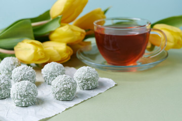 cup of tea and flowers and candies