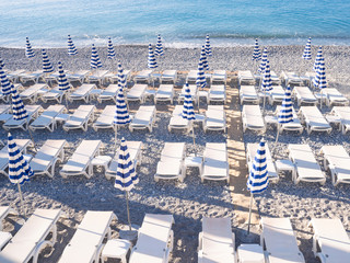 Sun beds and umbrellas on central beach of Nice France