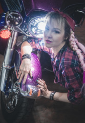 Fototapeta na wymiar Stylish blond woman posing with motorcycle.