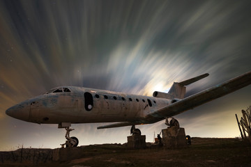 Old airplane and moon set. Beautiful cloudy sky, long exposure. 