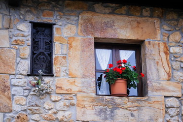 Fototapeta na wymiar Flowers at the window of a country house in Cantabria