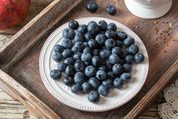 Fresh blueberries on a vintage plate on a table