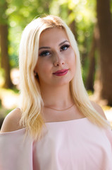 Portrait close up of young beautiful blond woman, summer outdoors