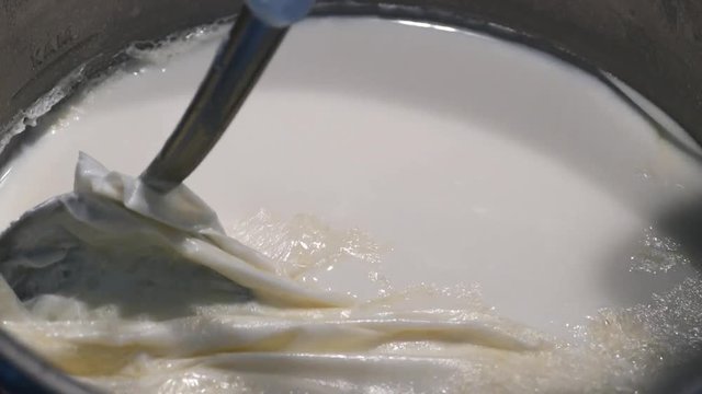 cooked milk and milk cream on it, The pellicle formed on milk, baked milk and formed slider layer, baked milk in a pot and milk cream on it,