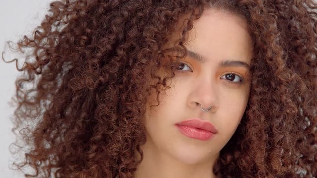 closeup panned video portrait of mixed race model with freckles watching