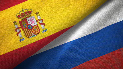Spain and Russia two flags textile cloth, fabric texture