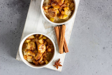 Rice pudding or porridge and fruits (apple, pear, banana and raisins) with honey or maple syrup and spices. Healthy breakfast or dessert.  