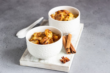 Rice pudding or porridge and fruits (apple, pear, banana and raisins) with honey or maple syrup and spices. Healthy breakfast or dessert.  