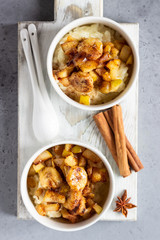 Rice pudding or porridge and fruits (apple, pear, banana and raisins) with honey or maple syrup and spices. Healthy breakfast or dessert.  