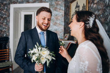 The first meeting of the wedding couple. Happy groom and bride looking to each other first time on wedding day