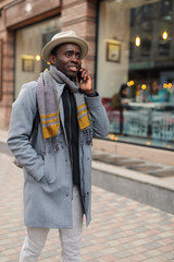 African man talks by smartphone in city