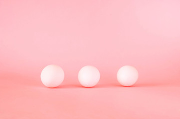 Festive easter background. White eggs on pastel pink background. 