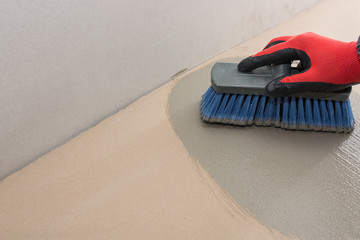 the beginning of application of the first waterproofing layer, on cement base