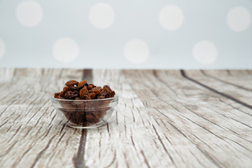 Dried raisins on a wooden background. Concept of eating dried grapes, snack eating fruit. Eating dried fruit.