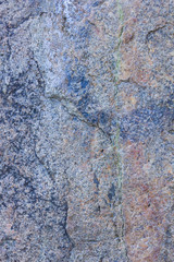 Granite texture close up. Granite rocks with porous surface. Background from solid stone. Pattern with natural material