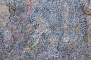 Granite texture close up. Granite rocks with porous surface. Background from solid stone. Pattern with natural material