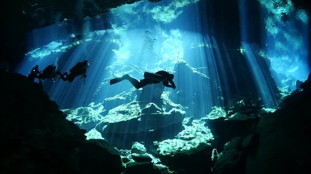 scuba diver exploring a cave