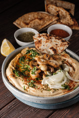 Traditional Mediterranean hummus with mushrooms and onions. Classic Hummus with paprika, olive oil, onions, mushrooms and seasonings