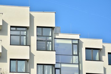Modern white building with balcony on a blue sky