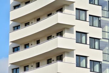 Modern white building with balcony on a blue sky