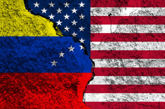 Flag of Venezuela and USA on the background texture of the shabby paint with a crack on the whole frame