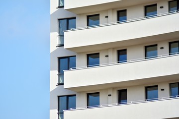 Modern white building with balcony on a blue sky