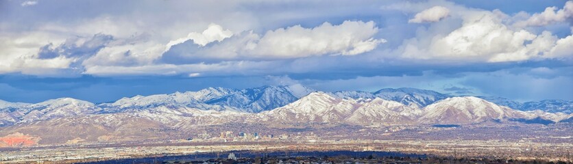 Winter Panoramic view of Snow capped Wasatch Front Rocky Mountains, Great Salt Lake Valley and...