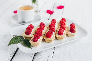 Mini tartlets with cottage cheese and fresh raspberries and a Cup of coffee