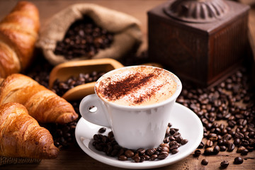  coffee cup close-up over dark roasted coffee beans