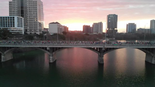 Aerial View of Thousands of People Running in the Austin Marathon across the Congress Street Bridge at Sunrise