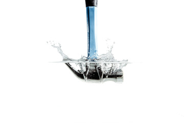 A hammer falling into the water. Hammering the water with a hammer and a great splash of water. The concept of failure, the impossibility of reaching an agreement. Construction renovation.